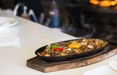 sizzling pork sisig with raw egg
