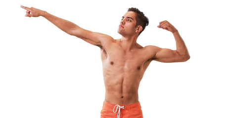 Happy Millennial Hispanic man posing in swim trunks on white background. Young guy doing silly poses having fun laughing.