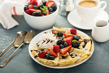 Thin crepes with whipped cream and berries