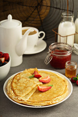 Thin crepes with strawberry and honey