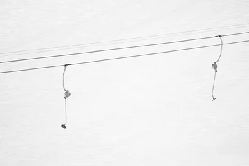 Cercles muraux Sports dhiver ski drag lift isolated in snowcapped mountains, texture background, ski concept in black and white