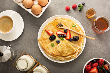 Thin crepes with berries and honey