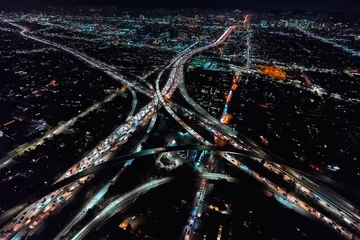 Fotobehang Aerial view of a massive highway in Los Angeles, CA at night © Tierney