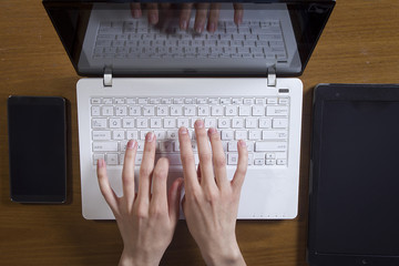 Female hands are working on a laptop computer