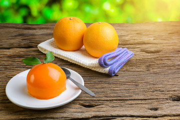 Orange cake on grunge wooden table