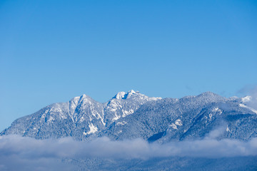 Mountains covered in snow and blue clear sky in nice winter day. © olegmayorov
