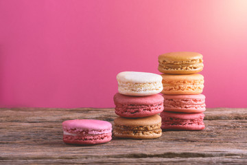 Different types color of macaroons on Old grunge wooden background