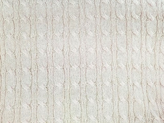 close up of cream colored cable knit pattern background