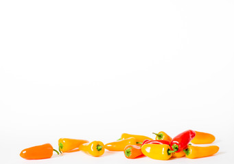 Scattered small hot chili peppers on white background