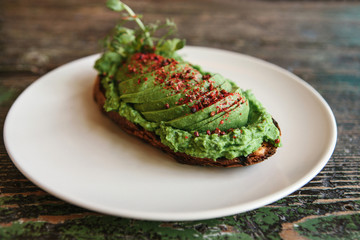 Sandwich with avocado on a plate. Delicious and healthy diet food.