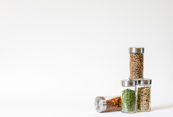 Four spice jars in a group with one lying down