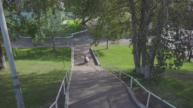 Aggressive inline roller blader grind on rail in skatepark outside. Clip. Summer extreme sport exercising outdoor in skate park. Various tricks