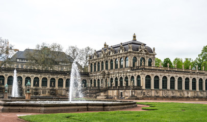 Fototapeta na wymiar Fountain of Nymphenbad and the palace of Zwinger. The Royal Palace in Dresden. Tourist attraction of Germany