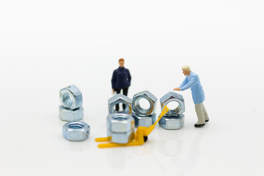 Miniature people: Worker pick up the screw. Image use for background business concept.