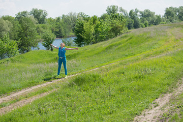 A red-haired young woman on nature background
