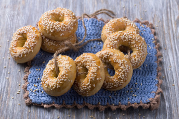 Traditional Greek Easter biscuits Paskhalina Kuluria with sesame seeds on a wooden table. Delicious homemade pastries