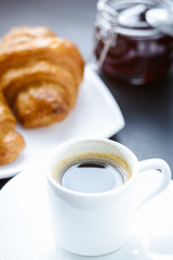 cup of coffee and croissants on the morning table