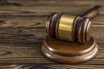 Gavel, hammer of judge on a wooden table.