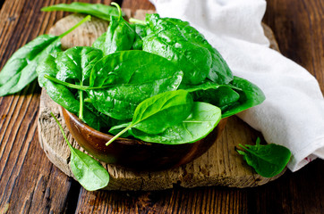 Fresh spinach on a cutting wooden board