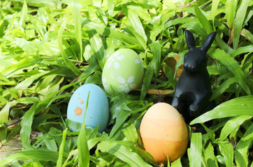 Easter eggs and rabbit decoration on green glass with macro close up for Easter festival concept