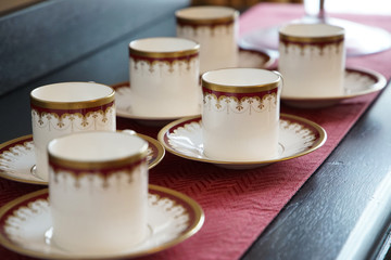 Spectacle of lots of tea cups on the table in the room