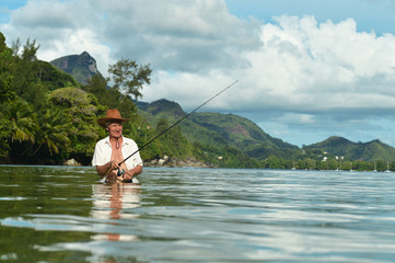 elderly man fishing in the sea