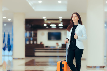 Elegant Business Woman with Travel Trolley Luggage in Hotel Lobby 