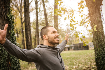 Sporty man with arms outstretched.