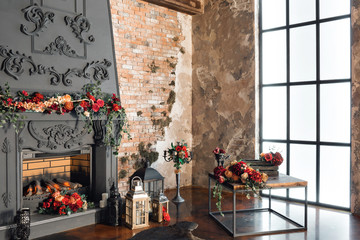 Interior with fireplace, candles, skin of cows, brick wall, large window and a metal cell of a loft, living room, coffee table in modern design