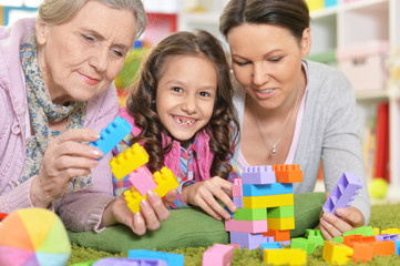 family playing with colorful plastic blocks