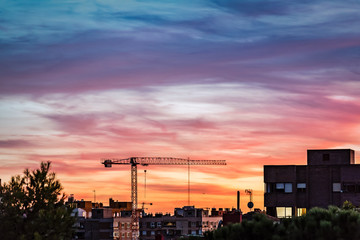 Construction crane on Madrid skyline at beautiful sunset