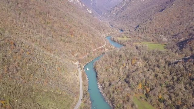 Mountain river in the gorge between rocks and trees, aerial view of Mountain landscape. Clip. Aerial view of a river, flowing between lava rocks and a mountain