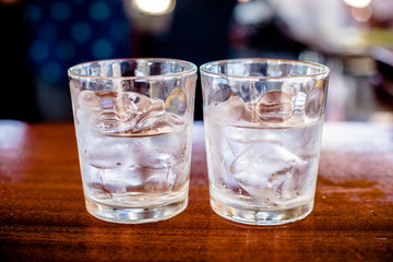 Two glasses of Malibu and ice on the bar counter