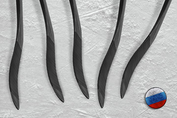Five hockey sticks and a Russian puck