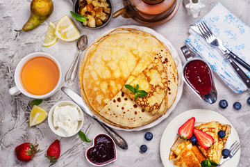 Colorful, tasty and savory breakfast with crepes and different fillings and sauces