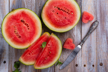 Fresh ripe watermelon slices and mint on wooden table