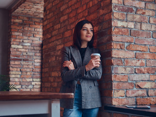 Portrait of a beauty businesswoman holds cup of a morning coffee