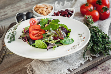 Salad diet for weight correction from the leaves of Lollo Rosso lettuce, watercress salad and other green herbs with tomatoes, olives and fitaki.