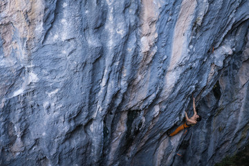 Bare torso men climbs a tufa rock with a rope, lead, Turkey