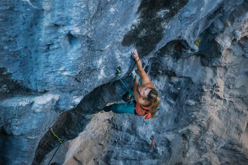 Blonde girl climbs tufa rock, Chitdibi, Turkey
