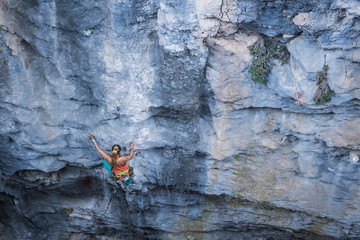 Blonde girl climbs tufa rock, Chitdibi, Turkey