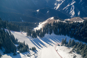 Aerial view of the Alpine skiing and snowboarding piste in mountains