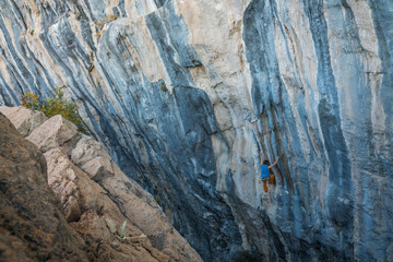 man climbs tufa rock, Chitdibi, Turkey