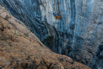 man climbs tufa rock, Chitdibi, Turkey