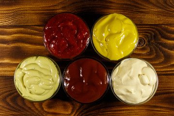 Set of sauces on wooden table