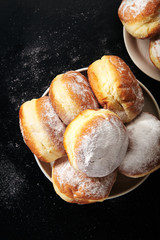 Sufganiyot donuts with jelly on black background
