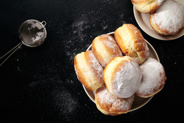 Sufganiyot donuts with jelly on black background