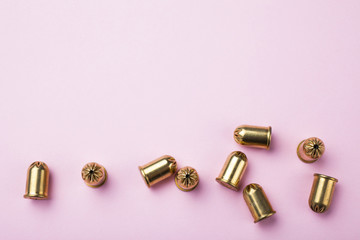 Vintage bullets on a pink background, empty space for text.