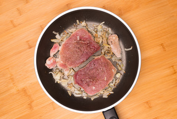 fried pork on a board made of mango tree