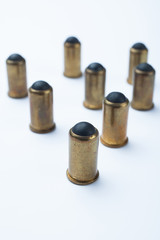 Old rubber bullets on a white background, selective focus.